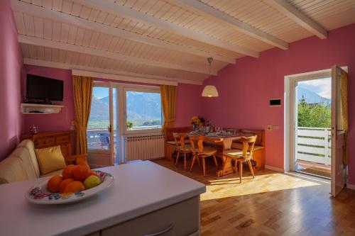 una sala de estar con una mesa con un bol de fruta en Casa del Sole, en Colico