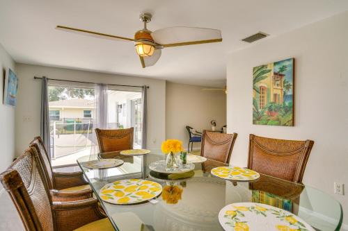 a dining room with a glass table and chairs at Heated Pool Canal-Front Rotonda West Retreat in Rotunda-West