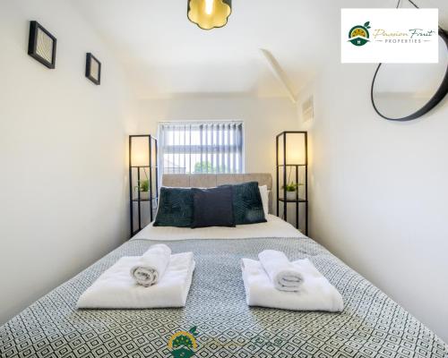a bedroom with a bed with towels on it at 3 Bedroom Coventry House By Passionfruitproperties with Free Wi-fi, Large Garden and Driveway - 52NRC in Coventry