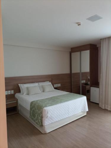 Condomínio Vista Azul Hotel tesisinde bir odada yatak veya yataklar