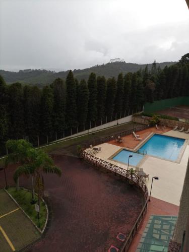 an overhead view of two swimming pools in a resort at Condomínio Vista Azul Hotel in Pedra Azul