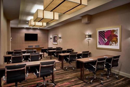 a conference room with tables and chairs and a tv at Sonesta Hotel Baltimore Inner Harbor in Baltimore