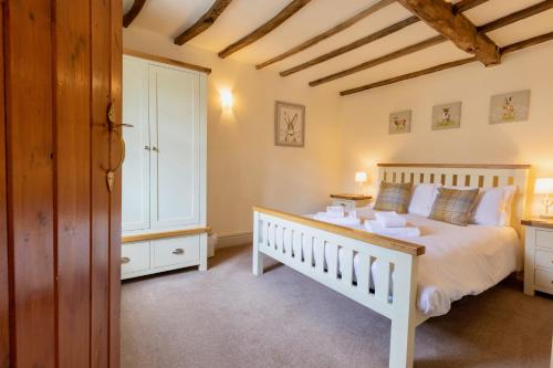 a bedroom with a white bed and a window at Character Cottage In West Burton, Wensleydale in West Burton