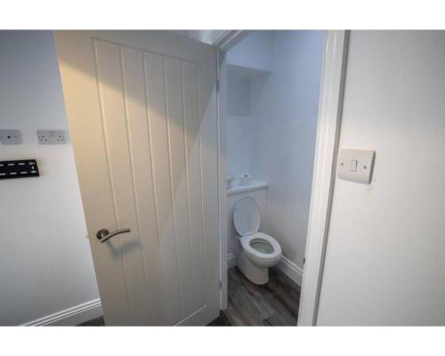 a bathroom with a white toilet in a room at Falmouth House 3 Bedrooms 5 Beds Workstays UK in Middlesbrough