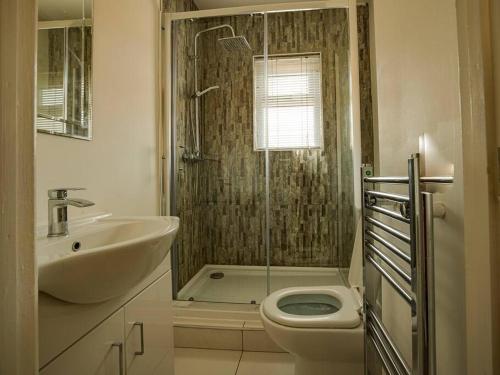 a bathroom with a shower and a toilet and a sink at Haddon House Workstays UK in Middlesbrough