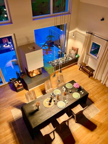 a living room with a table and a fireplace at Ferienhaus auf 7 ha Alleinlage - Pool,Whirlpool, Sauna - Das Refugium Südsteiermark in Lieschen