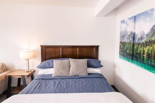 a bedroom with a bed and a painting on the wall at Alaska Frontier Inn in Delta Junction