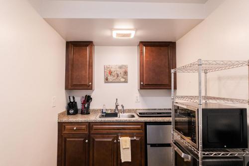 a kitchen with a sink and a stove top oven at Alaska Frontier Inn in Delta Junction