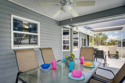 a dining room with a glass table and chairs at Screened-In Lanai and Yard Port Charlotte Retreat in Port Charlotte