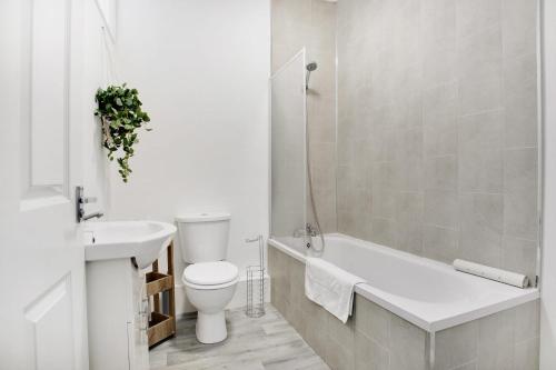 a white bathroom with a toilet and a sink at 2 Bed Cottage with Garden & Stunning Field Views in Durham