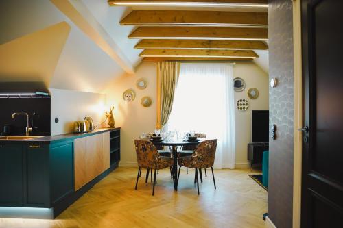 a kitchen and dining room with a table and chairs at Meerbach Residents in Kuressaare