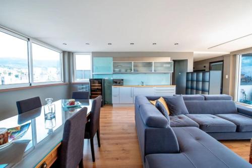a living room with a couch and a table at Luxury Loft by Boy in Patra