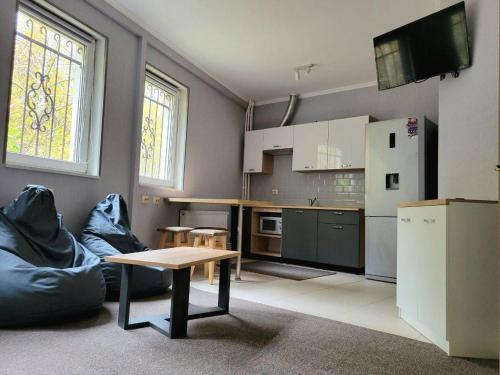 a kitchen with a couch and a table in a room at Апартаменти-студіо в Трускавці in Truskavets