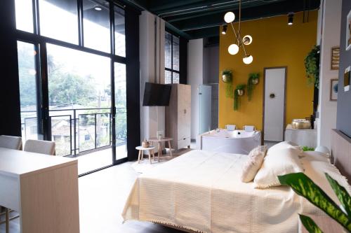 a bedroom with a large bed and a bathroom at Royal Living Poblado in Medellín