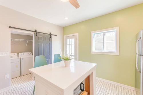 a kitchen with a white counter and a refrigerator at Modern, Charming Bungalow by the Park in Saint Paul