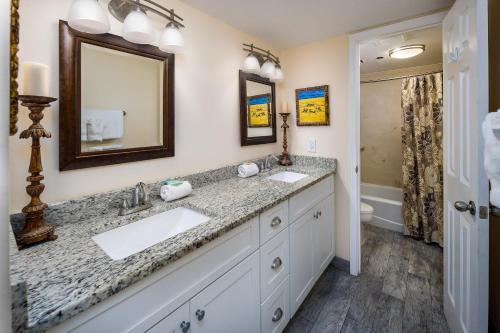 a bathroom with two sinks and a mirror at Nautilus 2411 Gulf View 2 Bedroom 4th Floor Free Beach Service in Fort Walton Beach