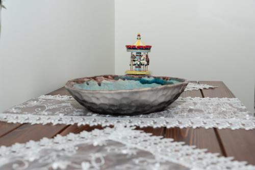 a bowl on a table with a white table cloth at casa zervos - Abode of Light in Loutraki