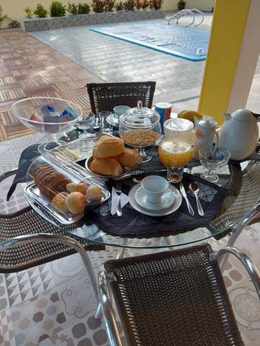 a table with a tray of food and drinks on it at Pousada Ninhal das Garças in Ilha Comprida