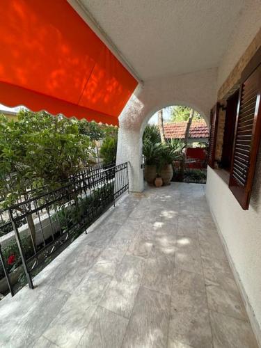 an outside walkway of a house with a balcony at Caja De Anthea in Artemida