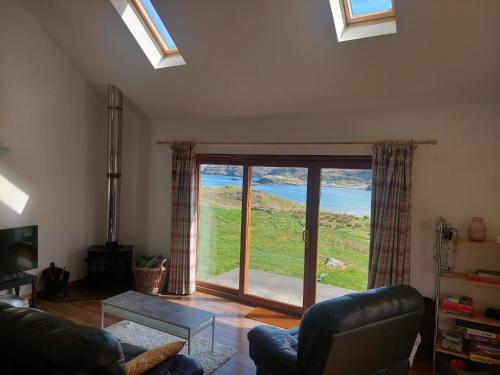 a living room with a view of the ocean at Ocean Surf in Clashnessie