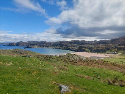 a view of a beach and a body of water at Ocean Surf in Clashnessie