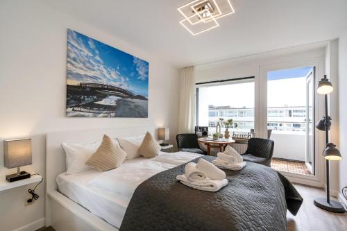 a bedroom with a bed and a large window at Strandnah in Westerland (Sylt)