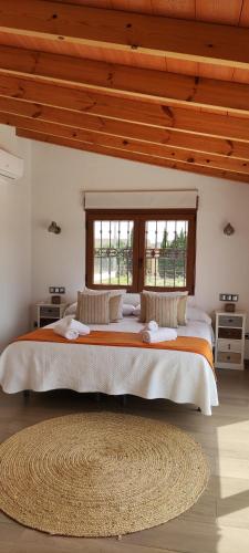 a bedroom with a large bed with a large window at Casa Rancho Grande in Jávea