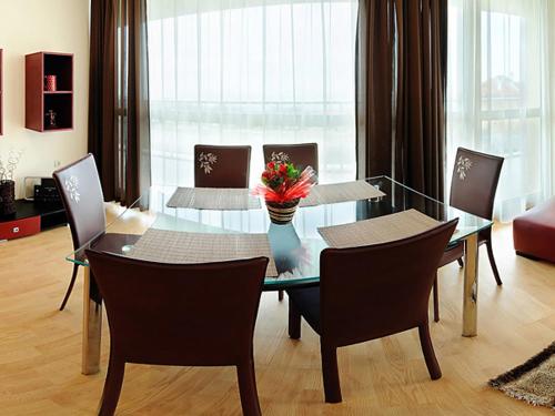 a dining room with a glass table and chairs at Sea Dream Rental Apartments in Varna City