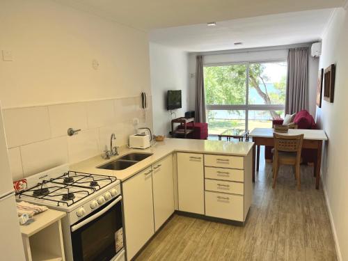 a kitchen with a sink and a stove top oven at Atardeceres Chascomús in Chascomús