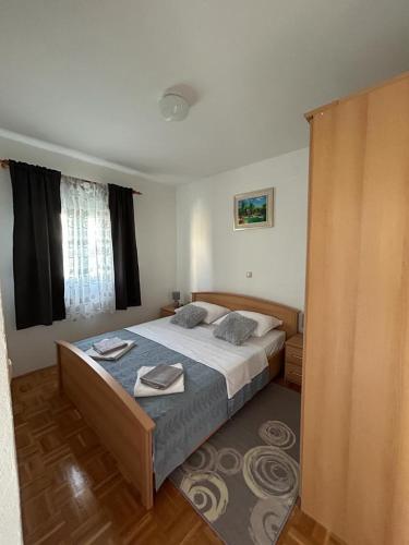 a bedroom with a large bed with towels on it at Apartments Marina in Posedarje