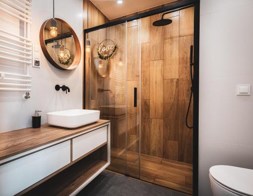 a bathroom with a sink and a shower at Pure Rental Apartments Inżynierska in Wrocław