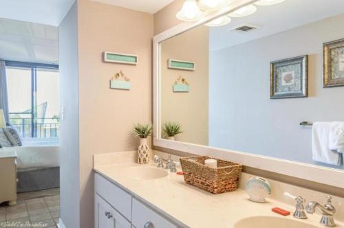a bathroom with a sink and a large mirror at Nautilus 2310 Gulf View 2 Bedroom 3rd Floor Free Beach Service in Fort Walton Beach