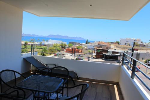 a balcony with chairs and a table and a view at Sawari Hotel in San Carlos