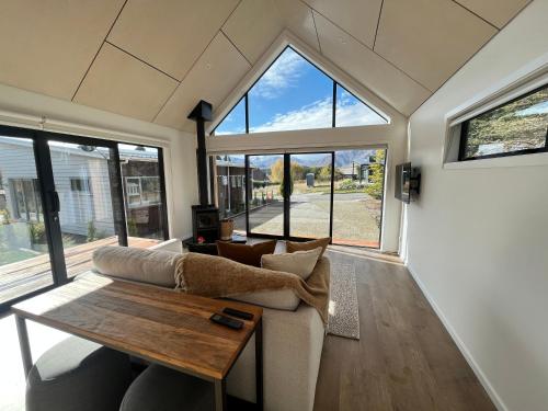 a living room with a couch and a table at Tekapo Toi Toi in Lake Tekapo