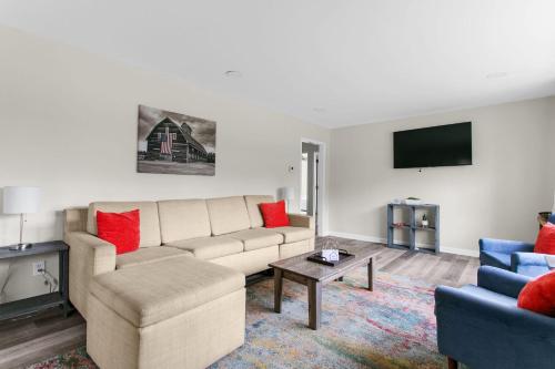 a living room with a couch and a tv at 10 Min to Downtown-Modern in Magic City-Both Units in Birmingham