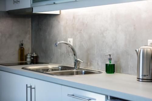 a kitchen counter with a sink in a kitchen at Nereides - Skinaria Beach Apartment in Damnoni