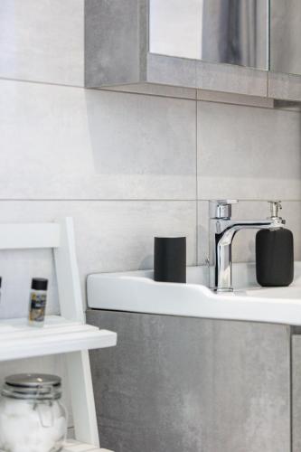 a bathroom with a coffee maker on a sink at Nereides - Skinaria Beach Apartment in Damnoni