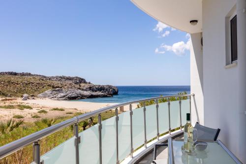 a balcony with a view of the beach at Nereides - Skinaria Beach Apartment in Damnoni