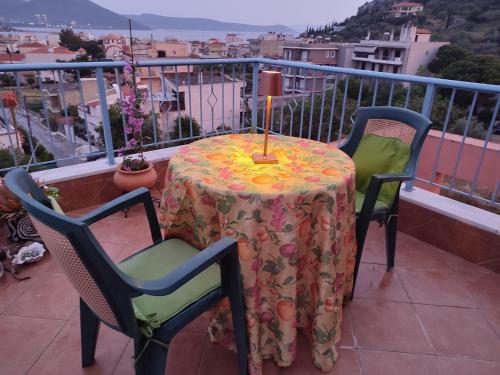 a table with a candle on top of a balcony at Maria GuestHouse in Aliveri
