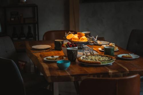a wooden table with food on top of it at Apartmany pod Pustevnami in Prostřední Bečva