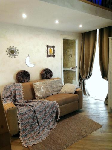 a living room with a brown couch in a room at Palazzo Emy in Lecce