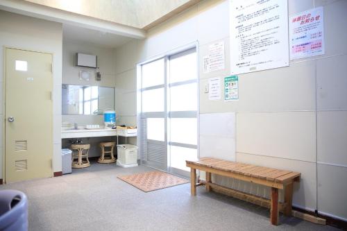 a room with a bench and a sink and a mirror at Pinneshiri onsen Hotel Bogakuso - Vacation STAY 31516v in Pinneshiri