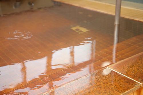 a tiled floor with a reflection of a building at Pinneshiri onsen Hotel Bogakuso - Vacation STAY 31617v in Pinneshiri