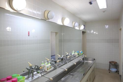 a bathroom with two sinks and a large mirror at Pinneshiri onsen Hotel Bogakuso - Vacation STAY 31617v in Pinneshiri