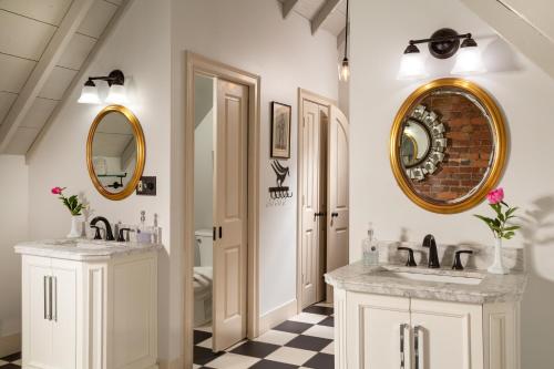 a bathroom with two sinks and a mirror at Inn at Woodhaven-In the Heart of the Bourbon Trail-Over 12 Distilleries Nearby in Louisville