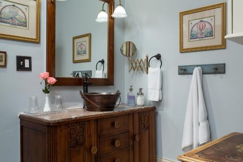 a bathroom with a sink and a mirror at Inn at Woodhaven-In the Heart of the Bourbon Trail-Over 12 Distilleries Nearby in Louisville