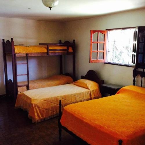 1 dormitorio con 3 literas y ventana en Tutu House en Salta