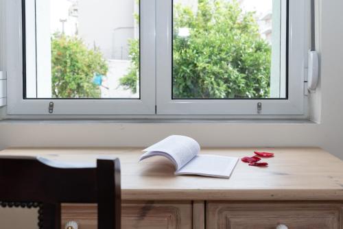 a wooden desk with a book and a book at casa zervos - Abode of Light in Loutraki