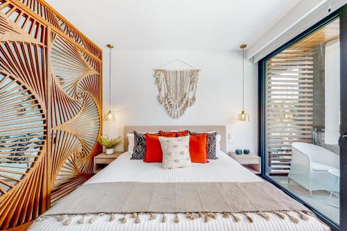 a bedroom with a large bed with red pillows at Perfect Place 302 in Playa del Carmen