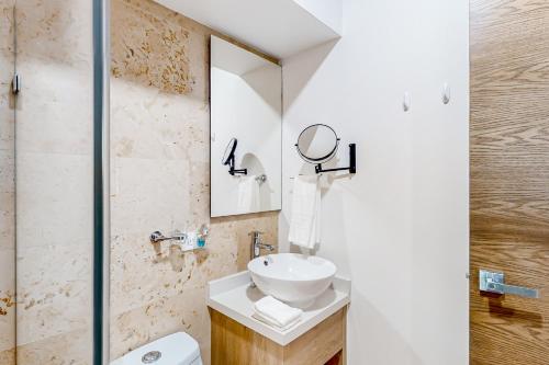 a bathroom with a sink and a mirror at Perfect Place 302 in Playa del Carmen